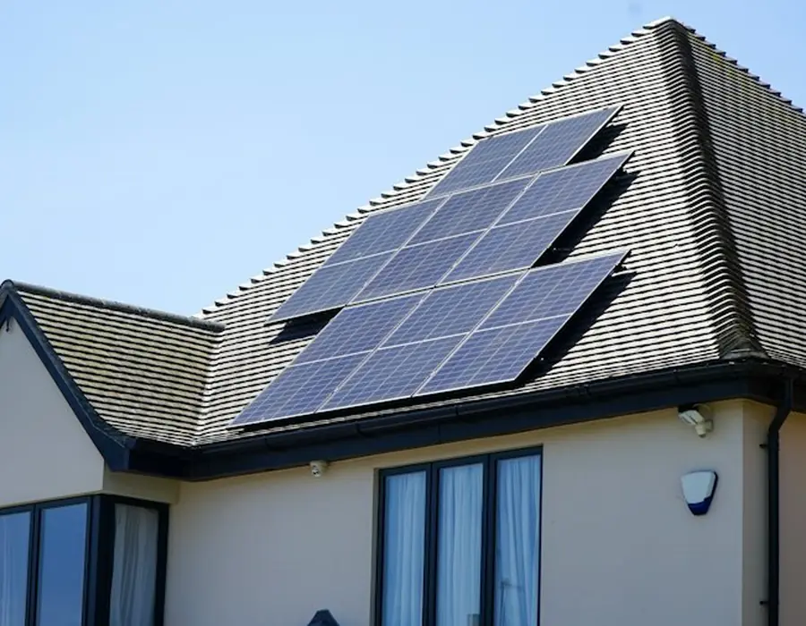 A modern house with solar panels along the roof line
